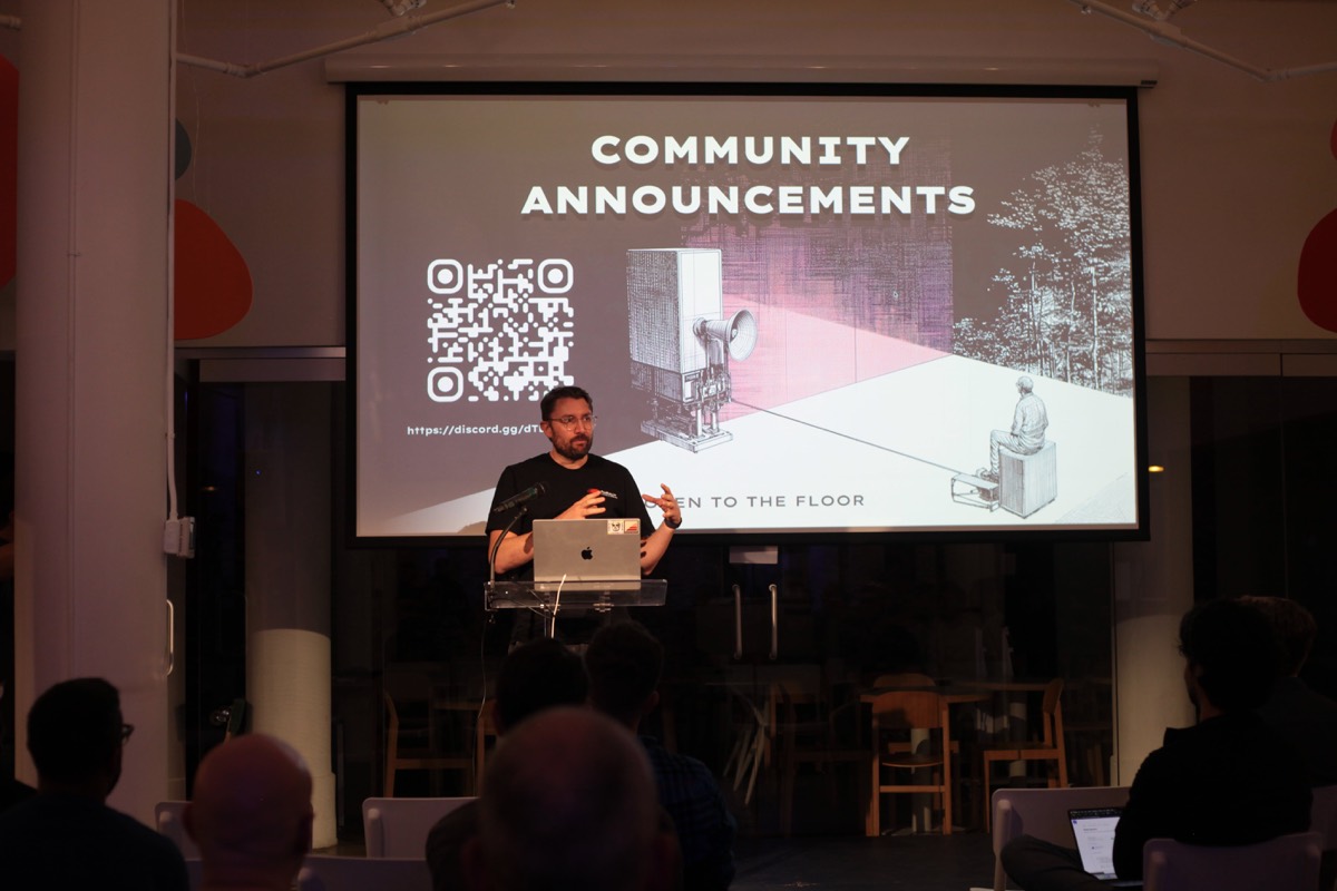 A community announcements slide on screen during an Artificial Ruby event